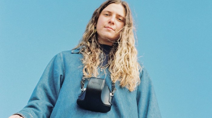 Rosie H Sullivan in a denim jacket with a camera around her neck
